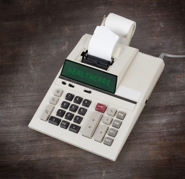 old calculator with HEALTHCARE written on display