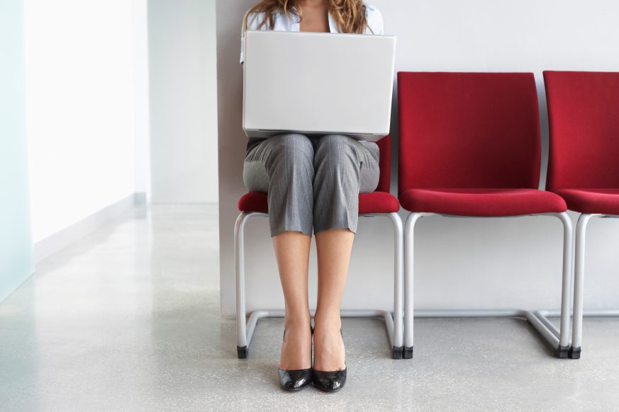 woman sitting in chair working at laptop