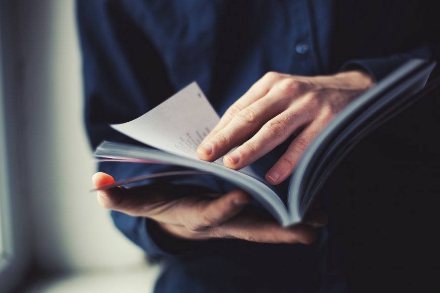 person looking over book