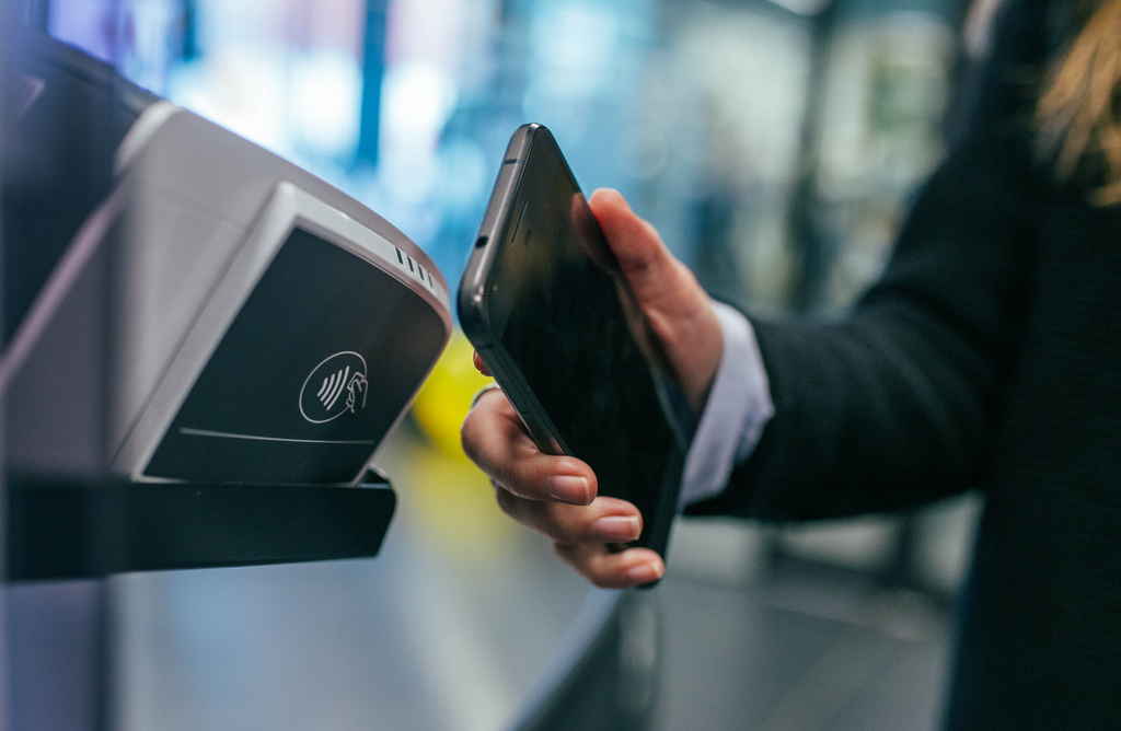 person scanning smart phone to pay for a purchase